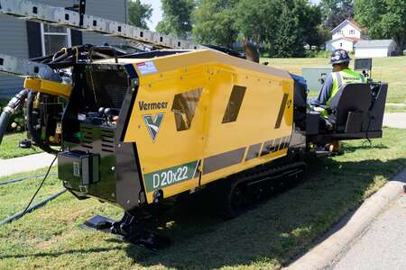 Crew with branded vests and machine